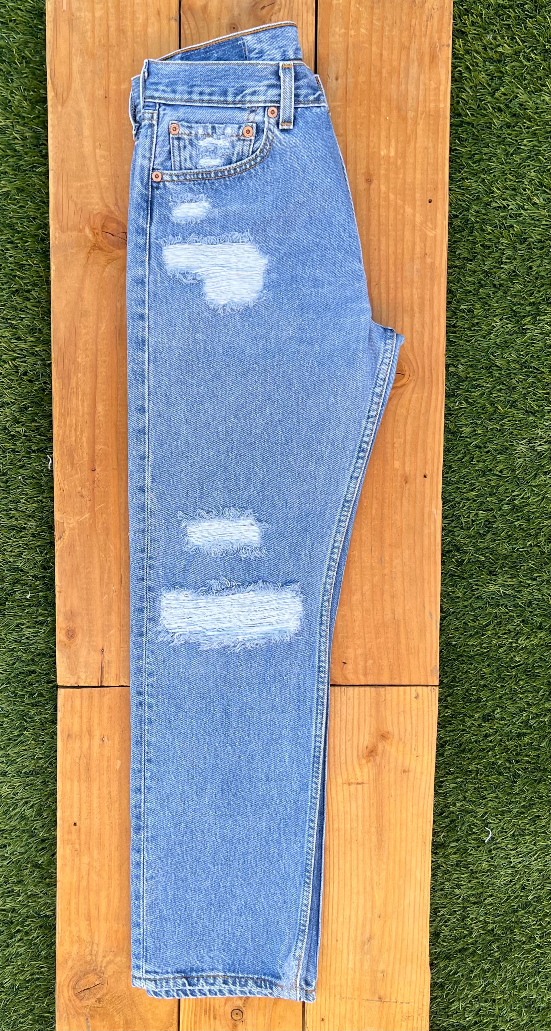 Levis with rip under top bum